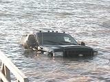 Officials pull vehicle and trailer from lake Officials pull vehicle and trailer from lake